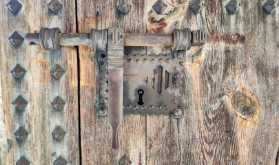 Old lock on wooden gate in Los Serrano tower in Valencia