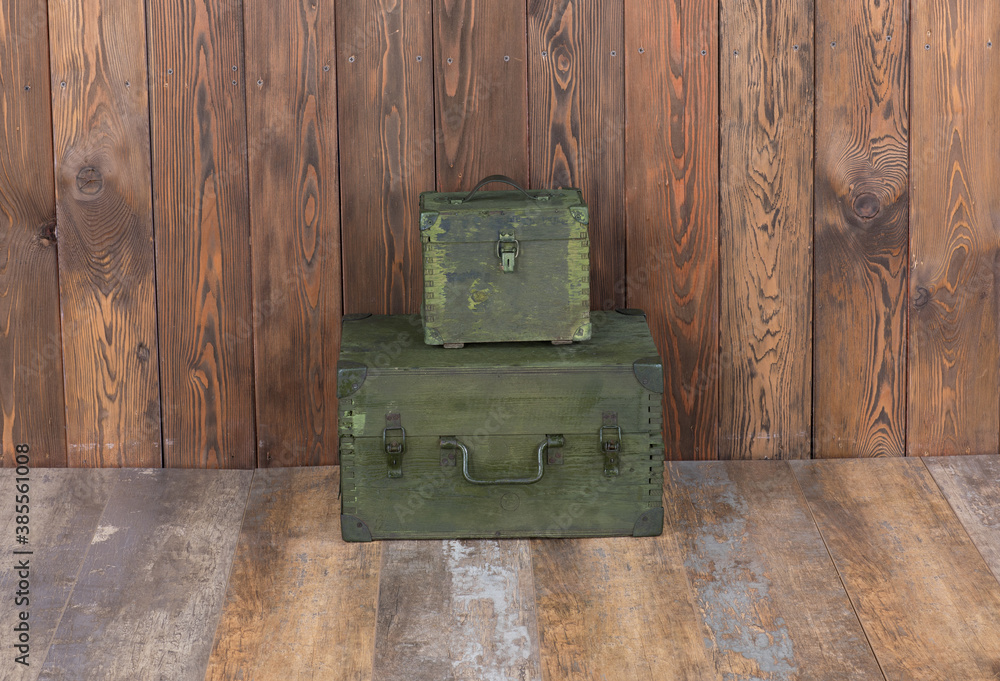 Wall mural green military boxes on a wooden background