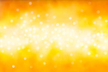 Christmas and New Year holidays blurred orange sparkles background, abstract background with bokeh defocused glittering lights and shadow