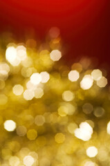 Christmas and New Year holidays blurred golden sparkles on red background, abstract background with bokeh defocused glittering lights and shadow