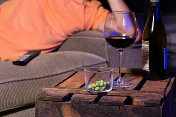 Young man watching movie, tv and eating snacks