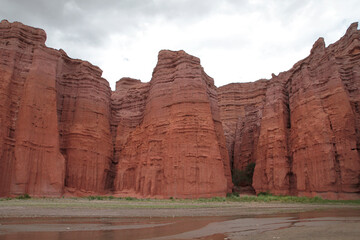 The canyon red cliffs and lake. Panorama view of the popular red sandstone and rocky formation called The Castles in Salta, Argentina.