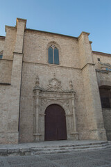 Fototapeta na wymiar Gothic Renaissance church facade with door and window in Torrijos, Toledo province. Spain