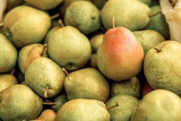 Green fresh ripe pears as background.