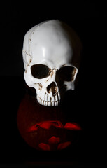 halloween 2020 and coronavirus. Happy halloween Carving. Halloween pumpkin head lantern on black background, with  human skull.  idea for halloween