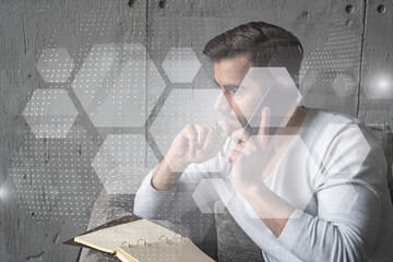 Handsome manager in casual wears, speaking phone, taking notes at office try to solve IT challenge from client. Double exposure. The concept of abstract technology.