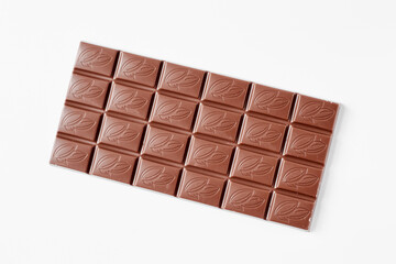 Milk chocolate bar isolated on white background