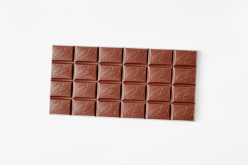 Milk chocolate bar isolated on white background