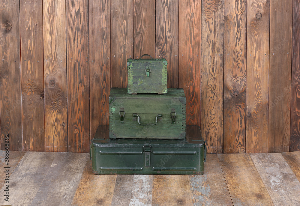 Wall mural green military boxes on a wooden background