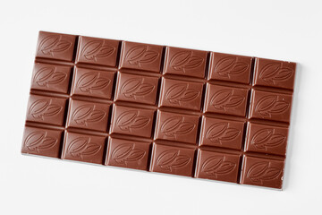 Milk chocolate bar isolated on white background