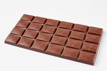 Milk chocolate bar isolated on white background