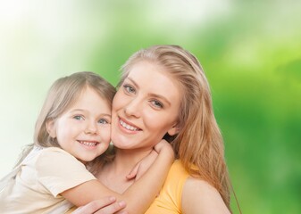 Happy beautiful mother and daughter hugging