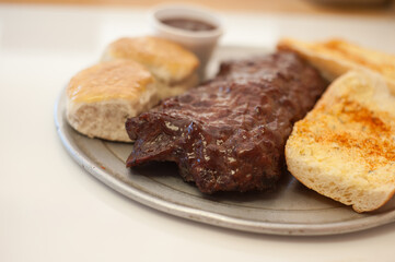 BBQ ribs with garlic bread and biscuits