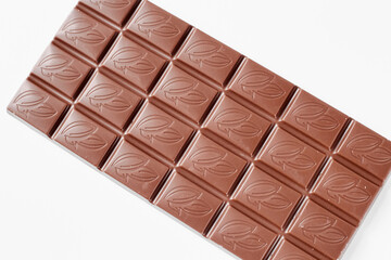 Milk chocolate bar isolated on white background
