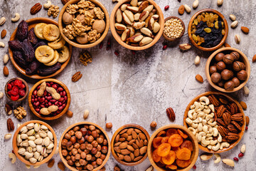 Various Nuts and dried fruits in wooden bowls.