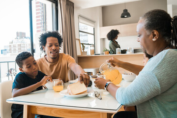 Family having breakfast together at home.