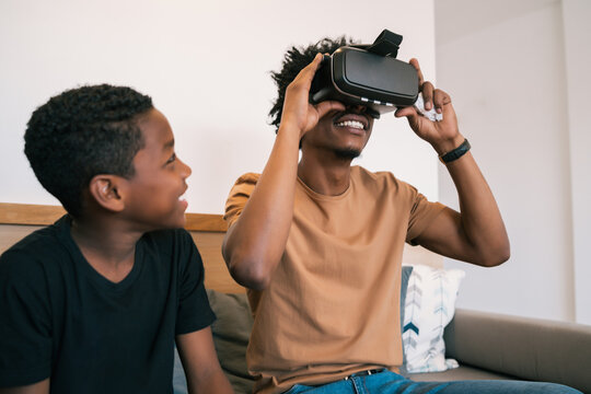 Father and son playing with VR glasses.