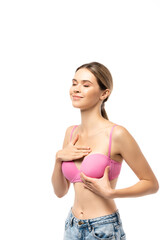 Obraz premium Young woman with closed eyes touching breast in pink bra isolated on white