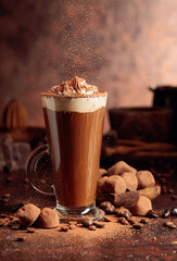 Truffles and glass of hot chocolate with whipped cream.