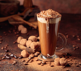 Truffles and glass of hot chocolate with whipped cream.
