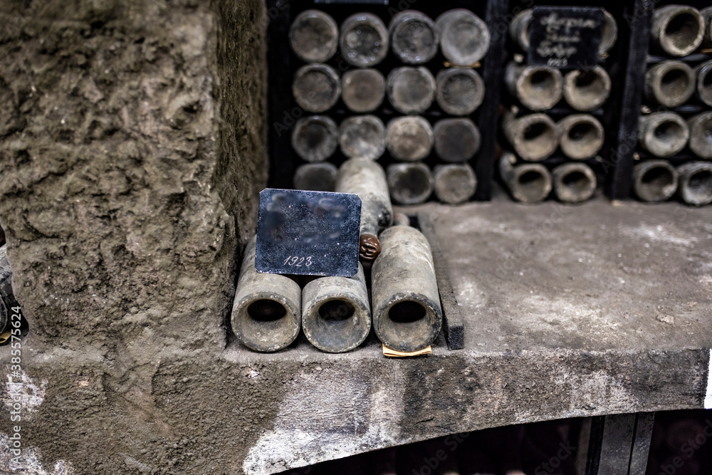 Fototapete old bottles with wine stored in special cellars and stored using special technology