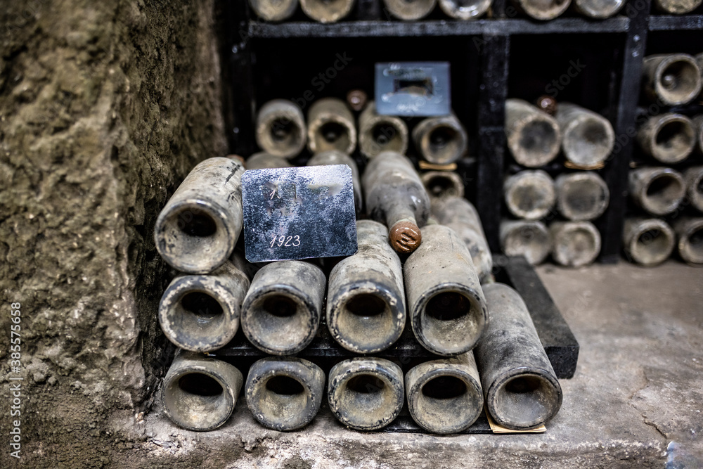 Fototapete old bottles with wine stored in special cellars and stored using special technology