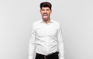 young handsome man with cheerful, carefree, rebellious attitude, joking and sticking tongue out,...