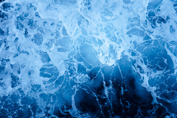 Photo from above of white foam of ocean waves crashing
