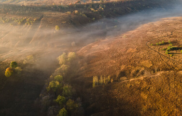 Aerial view to foggy valley autumn season