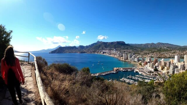 Calpe  coast from path above the city in the penon the ifach. Tourists visit Calp and Penyal d'Ifac Natural Park. View of Calp coast from a path above sea level.