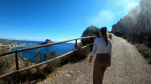 Calpe  coast from path above the city in the penon the ifach. Tourists visit Calp and Penyal d'Ifac Natural Park. View of Calp coast from a path above sea level.