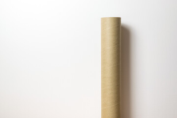 Cardboard tube on white wall background