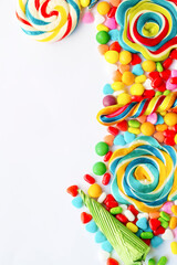 Obraz premium Colorful lollipops and different colored round candy. Top view.