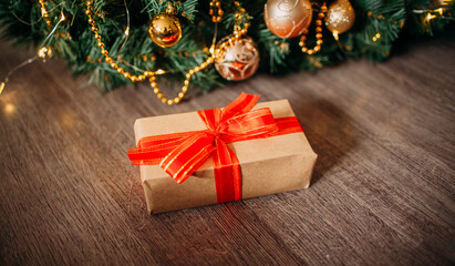 wrapped gift with red band with christmas background