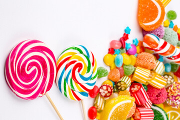 Colorful lollipops and different colored round candy. Top view.