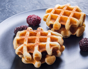 Viennese waffles and blackberries. Close up view
