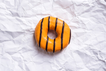 The caramel yellow donut on paper