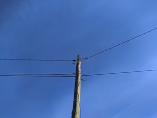 electronic pole with wires against the sky