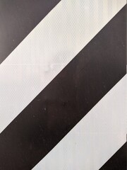 black and white striped road metal sign
