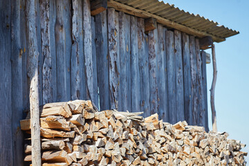 Stacks of firewood in the sawmill. Pile of firewood. Firewood background