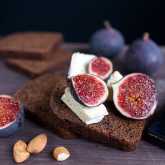 Bunch of fresh ripe figs on wodden brown background.