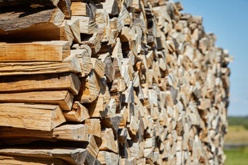 Stacks of firewood in the sawmill. Pile of firewood. Firewood background