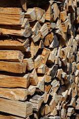 Stacks of firewood in the sawmill. Pile of firewood. Firewood background