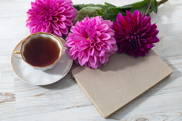 purple autumn dahlias on wooden grey white textured table background. Copy space. Frame for card and design