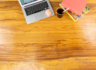 computer and books on wooden table