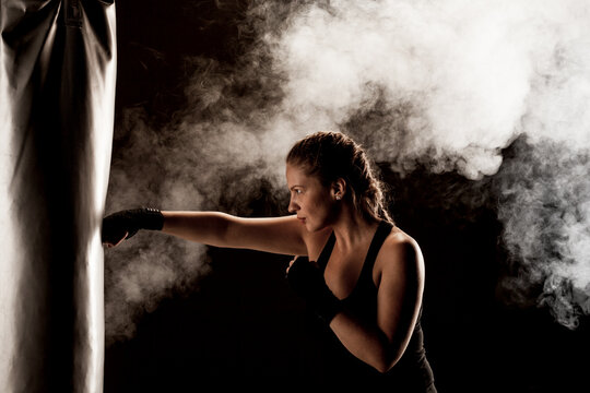 Kick Fighter Girl Punching A Boxing Bag