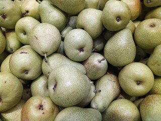 lot of green pear in the store closeup photo