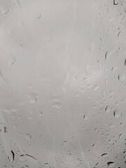 raindrops on glass on a gray background