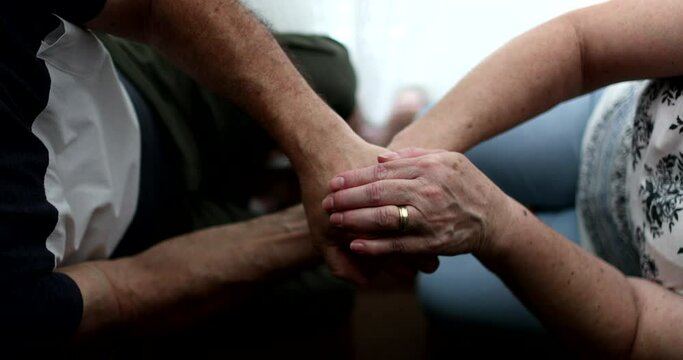 Older people holdings hands in support and empathy