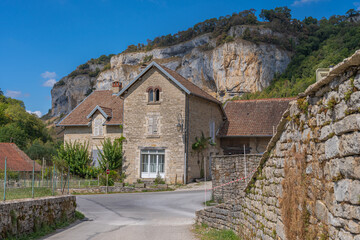 Baume-Les-Messieurs, France - 09 01 2020: View of the village of Baume-les-Messieurs and cliffs behind